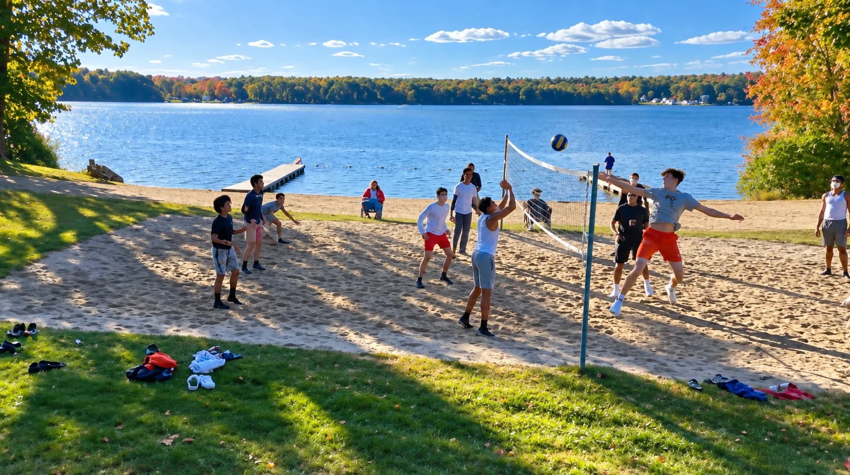 Young people playing volleyball beside a lake