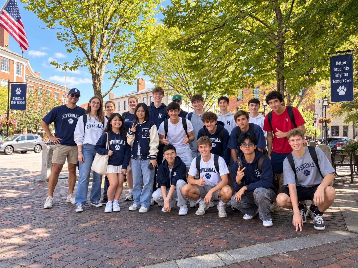 Students gathered on a tree-lined walkway beside school buildings