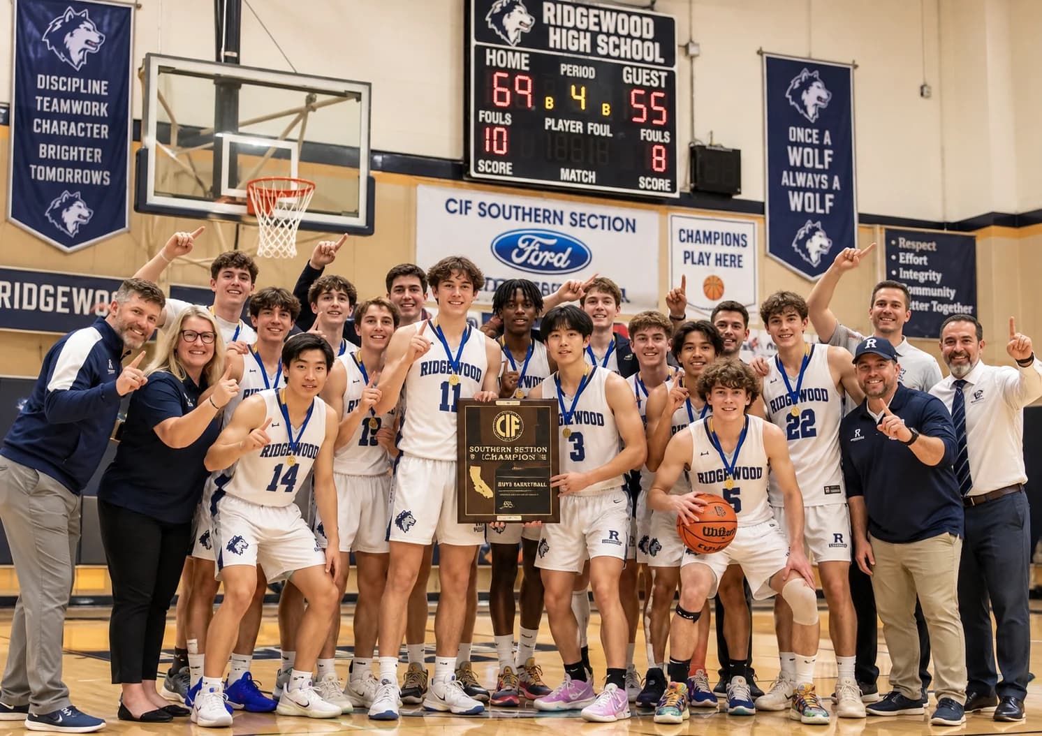 A school basketball team celebrating together in a gym